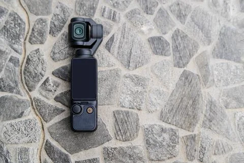 Action or mini pocket camera on the stone natural patterns floor background.. Foto stock