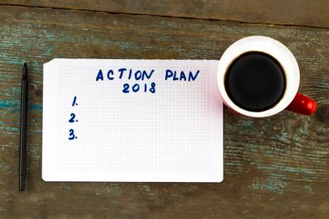 "Action plan" text on paper, with cup of coffee and pen on the wooden table - Stock Photos