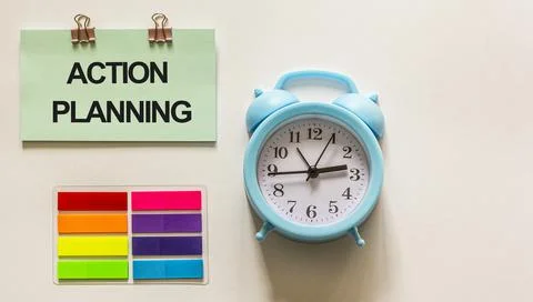 Action planning , text on a sticker, next to colored stickers and a blue alar Fotos de archivo