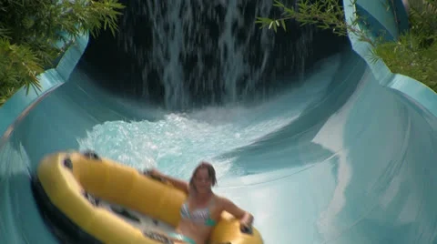 Action Shot of a Person Speeding Down a Water Slide in a Big Tube Video stock 24687771