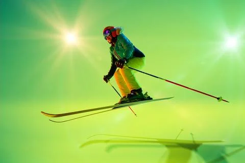 Action shot of skier leaping forward, as she jump over obstacles vibrant motion Stock Photos