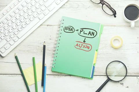 Action text on notebook on desk Stock Photos