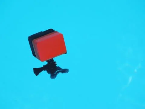 Action video camera with mount swims in the pool. Stock Photos