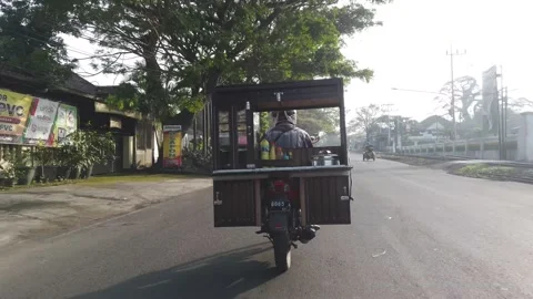 Action video, meatball vendors using motorbike Stock Footage 198438990