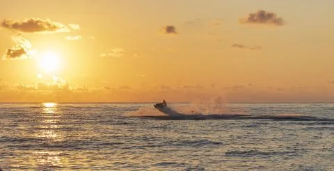 Action view of a jet ski jumping over a wave with a dramatic water splash d.. Stock Photos