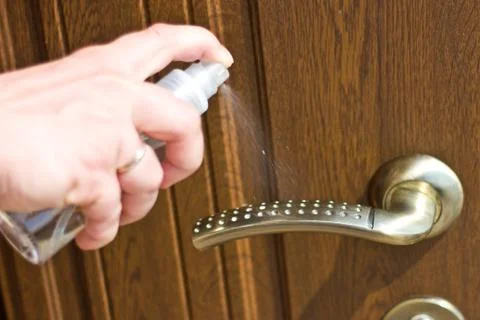 Actions to prevent the spread of COVID-19 coronavirus, door handle disinfecti Stock Photos