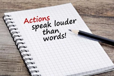 Actions speak louder than words! Text on notebook Stock Photos