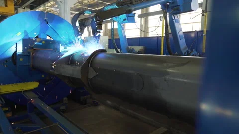 Actions of two robotic welding equipment in a tractor manufactory Stock Footage 130209144
