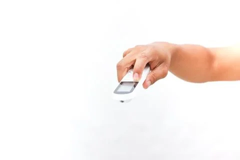 Activating Comfort: Hand Using a Remote Control for Temperature Adjustment 스톡 사진