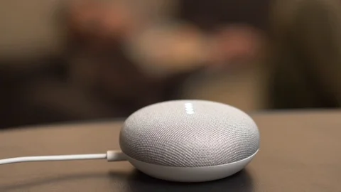 Activating a Smart Home Assistant Speaker By Voice Google Home Mini 库存影片 100907994