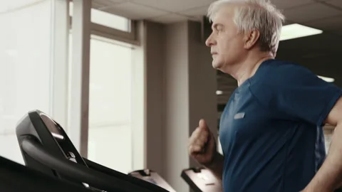 Active 50s or 60s Man Working Out at Gym Hall Closeup. Fitness Training Group or Видео 199478908