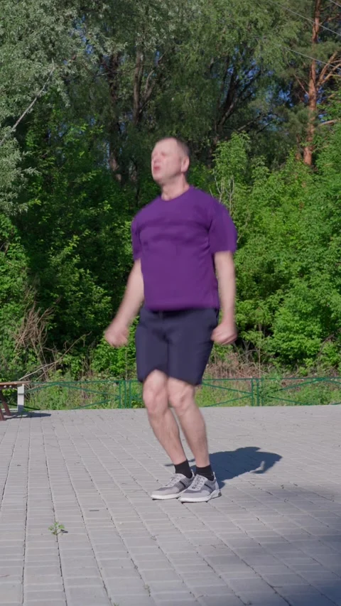 An active 62-year-old man does exercises on a sports ground. Stock Footage 310779575