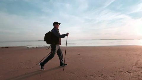 Active 70s aged man backpacker hiking walking stick outdoor sport activity at Stock Footage 220022448