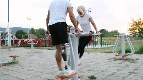 Active amputee exercising with his friend outdoors Stock Footage 292234774