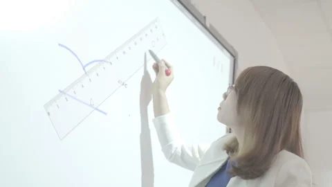 Active and caring teacher is teaching at elementary school Stock Footage 134231733
