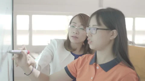 Active and caring teacher is teaching at elementary school Stock Footage 134231773