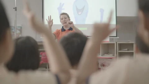 Active and caring teacher is teaching at kindergarten Stock Footage 134231839