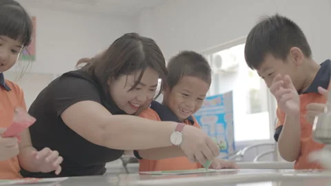 Active and caring teacher is teaching at kindergarten Stock Footage 134231878