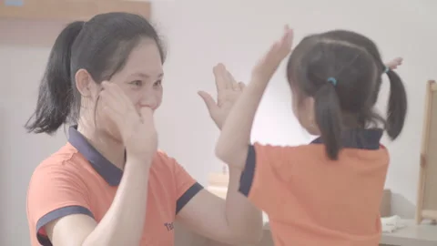 Active and caring teacher is teaching at kindergarten Stock Footage 134231965