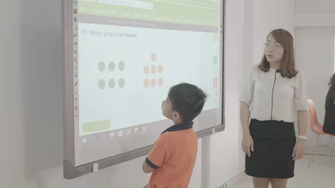 Active and caring teacher is teaching at kindergarten Stock Footage 134232014