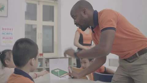 Active and caring teacher is teaching at kindergarten Stock Footage 134232089