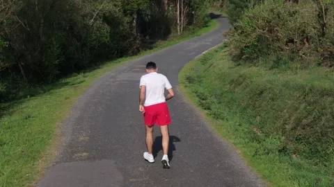 An Active And Fit Man Running On A Sunny Morning. Tracking Shot Stock Footage 310954841