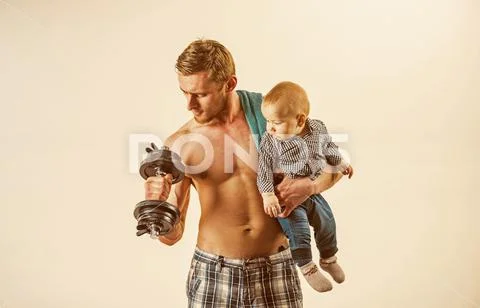 Active and sporty. Father build biceps triceps with son. Strong man with Stock Photos