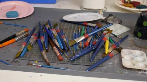 Active art studio with scattered brushes Stock Footage 311944425