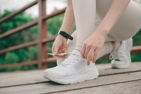 Active athlete runner tying shoelace on sneaker for sport exercise, prepari.. Stock Photos