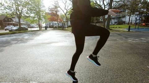 Active athletic girl doing leg worm up exercises on playground sunrise. Stock Footage 109500152