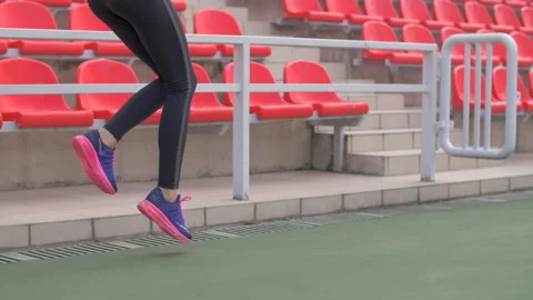Active athletic girl doing leg warm up exercises at the stadium 動画素材 140365891