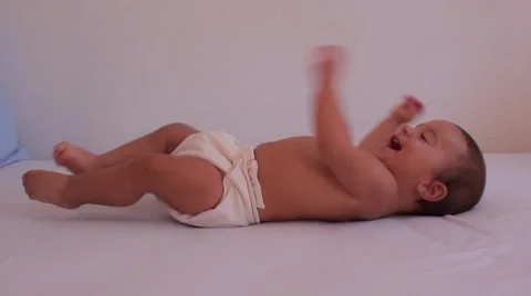 Active baby on bed Stock Footage 40932711