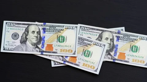 Active background flying in hundred dollar bills on a black background Video stock 82404874