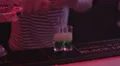 Active bartender making and serving alcohol shots to nightclub party guests HD Footage