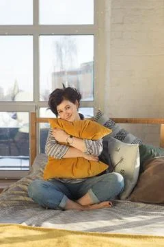 An active, beautiful middle-aged woman with a beautiful smile. Sitting on the Stock Photos