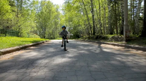 Active boy in blue helmet riding his bike Stock Footage 50140242