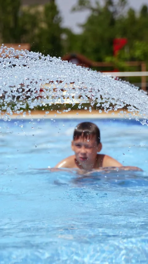 Active boy enjoys in the swimming pool.  Stock Footage 300791784