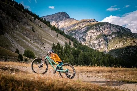 Active boy pushs up his bicycle. Little rider with mountain bike. Enduro riding Stock Photos