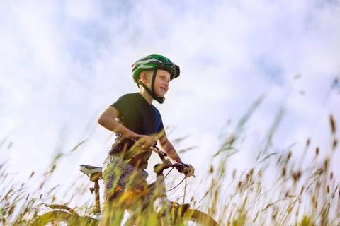 Active boy rides a bicycle Stock Photos