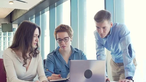 Active brainstorm of the creative team of young workers using laptop Stock Footage 73412624