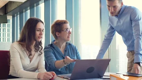 Active brainstorm of the creative team of young workers using laptop Stock Footage 73412712