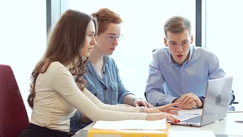 Active brainstorm of the creative team of young workers using laptop Stock Footage 73444652
