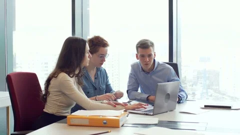 Active brainstorm of the creative team of young workers using laptop Stock Footage 73552277