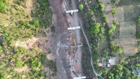 Active bridge construction and heavy machinery in Mountainous Rural India Stock Footage 335641318