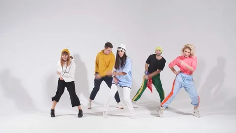 Active cheerful dancers posing over pink background after concert Video stock 120943531