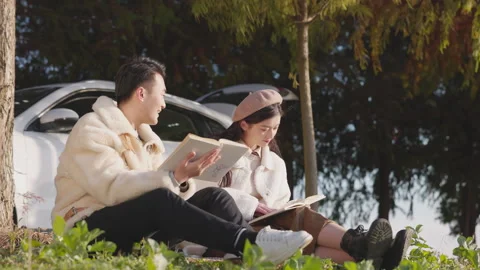 Active cheerful romantic loving couple cuddling enjoying time reading book 库存影片 336705526