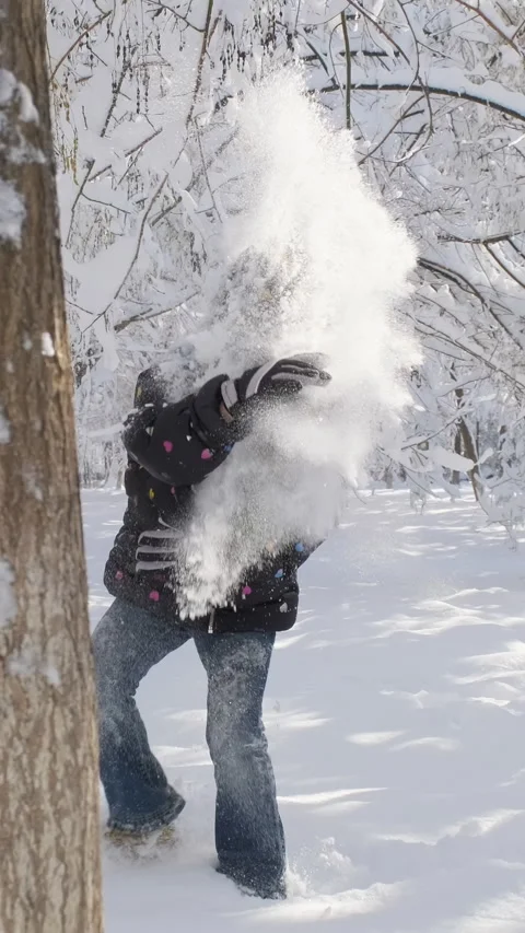 Active children having fun playing with snow in a beautiful park Stock Footage 297840640