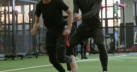 Active Chinese children having exercise class with their coach in gym,4K Stock Footage 156589630