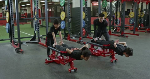 Active Chinese children having exercise class with their coach in gym,4K Stock Footage 156599970