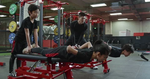 Active Chinese children having exercise class with their coach in gym,4K Stock Footage 156600505